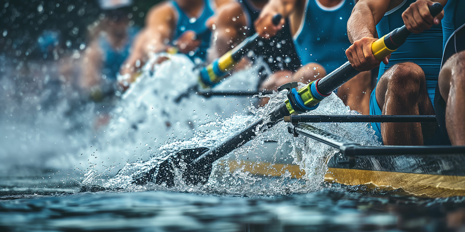 An intense moment capturing a team of rowers in perfect sync